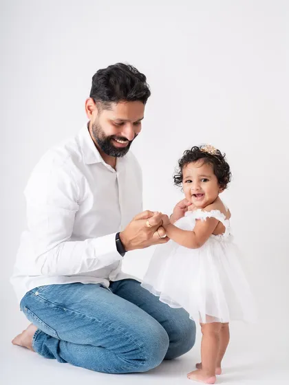 The pride and joy on this father's face as he helps his daughter take a step is a beautiful thing to witness and capture.