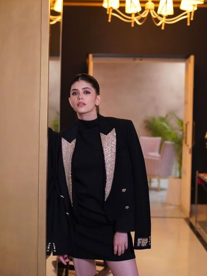 A full-length shot showing how a simple, well-executed ponytail can be the perfect finishing touch to a glamorous look.