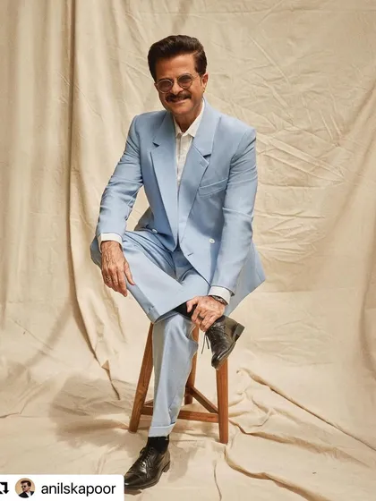 A relaxed yet dapper pose, with the hair looking effortlessly styled.