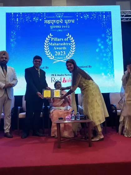 A proud moment on stage as our franchisee accepts the Pillars of Maharashtra award on behalf of The Bake Shop.