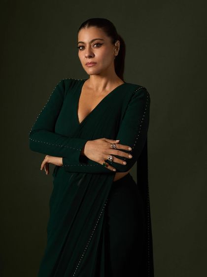 A detailed shot focusing on the stacked rings and the texture of the custom saree, perfect for a best actress win.