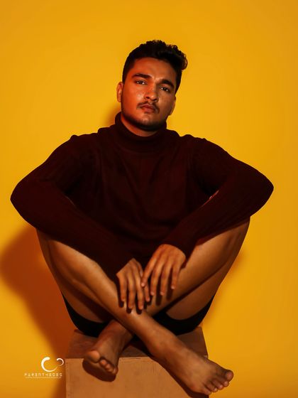 A symmetrical and grounded pose that exudes a sense of calm and confidence. The lighting is soft, creating a gentle mood.