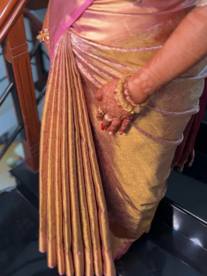The secret to a perfect saree look is in the details. Here is a close-up of my signature pleating on a heavy silk saree. Each pleat is precisely folded and secured to create a flawless, cascading effect that lasts all day.