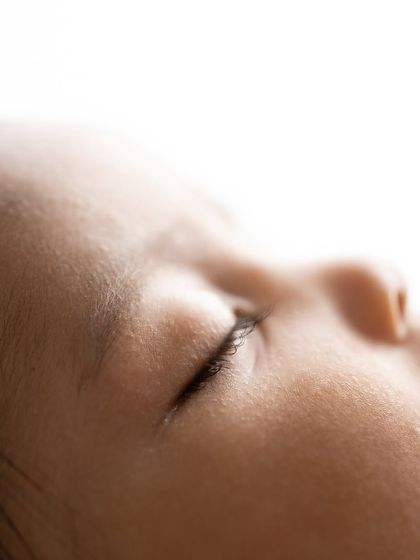 A close-up of a baby's delicate eyelashes as they sleep. Capturing these peaceful details is a key part of my newborn photography style.