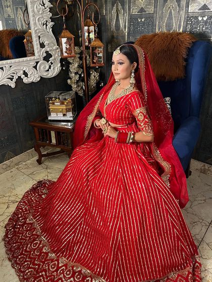 A full-length shot of this stunning bride in her red lehenga. The entire look is a perfect blend of tradition and modern glamour.