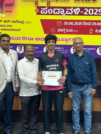 Abhinav V Murthy receives his award for winning the Under 19 Boys Singles Title for the second consecutive time at the 2nd Karnataka state ranking tournament.