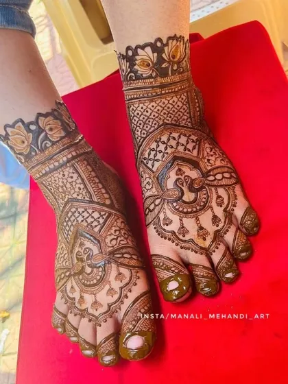 This is an example of my intricate foot mehandi work, perfect for a bride. The design features a central peacock motif surrounded by delicate patterns, with a matching floral band around the ankle.