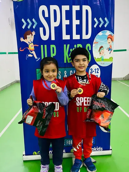 Our two 'Most Valuable Kids of the Month', Khiansh and Nyra, showing off their medals and prizes.