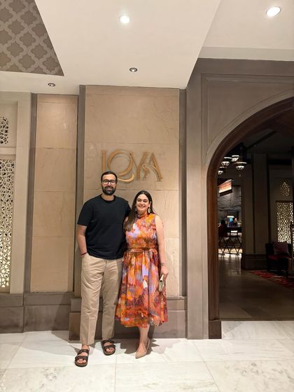 A picture with my partner outside Loya. Including personal moments makes my content more relatable and shows that these are places I genuinely enjoy with my loved ones.