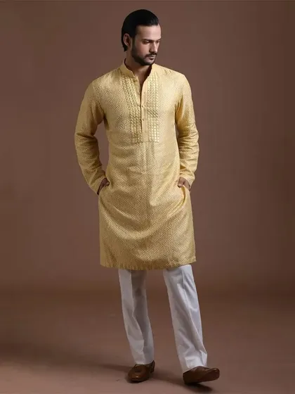 A textured yellow kurta with a detailed placket. This outfit combines subtle texture with a classic design for a refined and comfortable ethnic look.