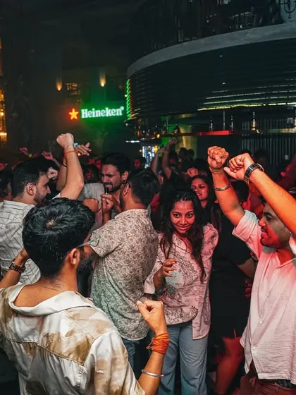 Hands up for the weekend! This shot captures the pure, unfiltered joy of a crowd letting loose to some heavy basslines and throwback tracks.