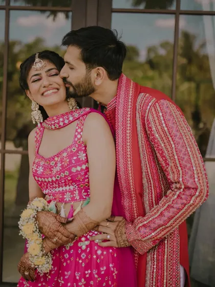 The Haldi ceremony is pure, unadulterated happiness. We focus on capturing the genuine smiles, the playful moments, and the love shared between family and friends. This candid shot is a perfect example of the warmth and energy we preserve.