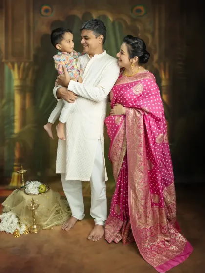 There's nothing more beautiful than capturing the whole family's excitement. This studio portrait, with everyone in coordinated traditional wear, shows the love and anticipation as you wait for your new arrival.