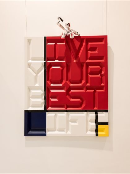 "Live Your Best Life" reimagines Mondrian’s modernist vision with a motivational twist. The carved quote is a powerful mantra, while the chrome figure on top adds a playful touch.
