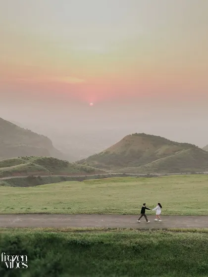 Monil and Charmi walking into the sunset. I often use wide shots like this to create a sense of journey and adventure, placing your love story within a vast, beautiful world.