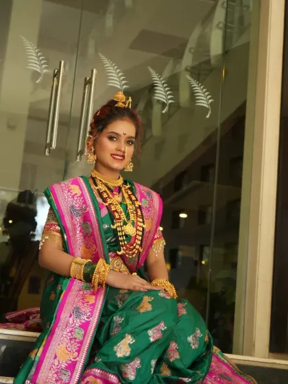 A beautiful portrait of the bride seated, her reflection captured in the glass behind her.