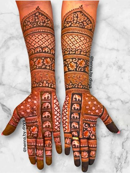 A majestic full-coverage bridal design featuring columns of elephants. This intricate pattern extends all the way up the arms, perfect for a bride seeking a royal and traditional aesthetic.