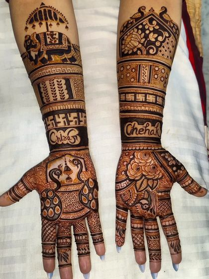 This personalized mehandi includes the client's name "Chehak" written in a stylish font. The design is filled with auspicious symbols like elephants, peacocks, and swastikas.