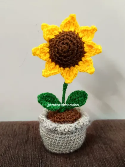 A detailed shot of the mini crochet sunflower pot. Every stitch is made with care to create a beautiful, lasting flower.
