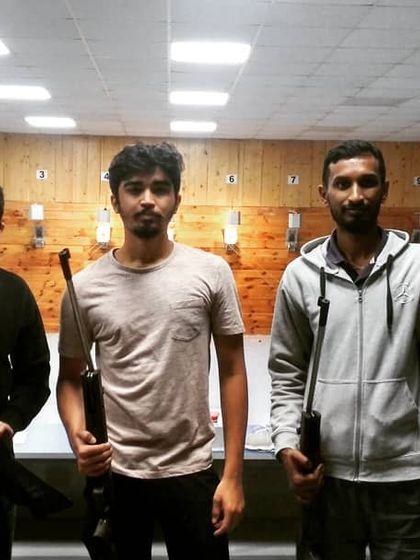 Three friends ready for their turn at the shooting lane. Our coaches ensure everyone understands the safety rules and proper handling before they begin.