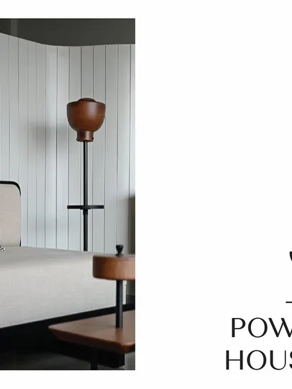 A quiet corner in the Powai House living room, featuring a daybed and a custom-designed floor lamp. The vertical white paneling adds texture and height to the wall, while the minimal furniture maintains the room's airy and uncluttered feel.