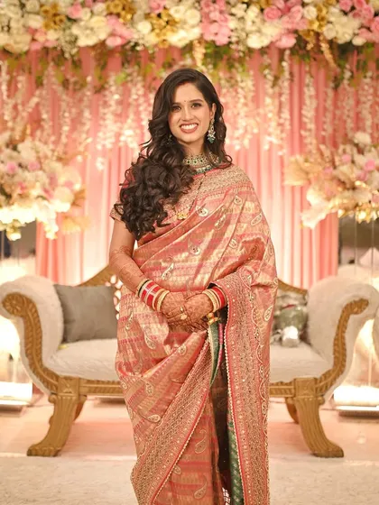 A quick change for the reception, from a traditional Marathi bride to a modern glam look. This shows how we can create multiple distinct styles for your different wedding events, complete with soft curls and elegant makeup.