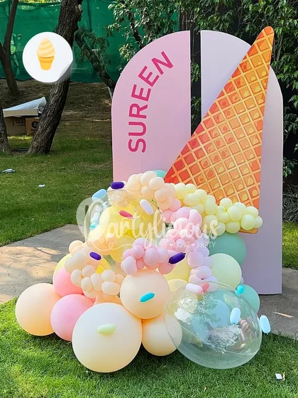 A close-up of our 'fallen ice cream cone' balloon sculpture. This playful and creative piece is made from a variety of pastel-colored balloons and is a unique photo-op for any party.