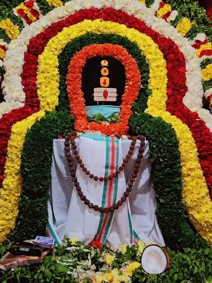 This is a sacred Shiva Lingam, elaborately decorated with flowers for a special puja. Worshipping Lord Shiva brings spiritual wellness and helps in the journey towards a balanced, Satvik lifestyle, which is a core part of my guidance for achieving mental clarity and inner peace.