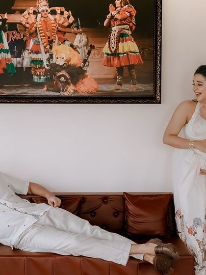 A candid shot from an at-home maternity session, showing the couple in their own environment.