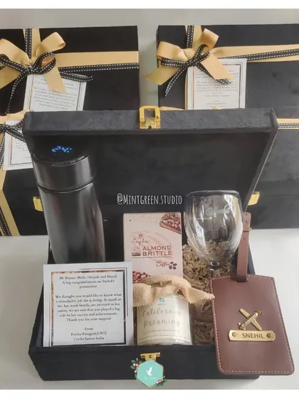 For corporate gifting that feels personal and premium, I curated these elegant black suede boxes. Each hamper includes a mix of practical and luxury items like a temperature-display flask, a personalized leather luggage tag, gourmet almond brittle, and a wine glass, all designed to make your employees and clients feel truly valued.