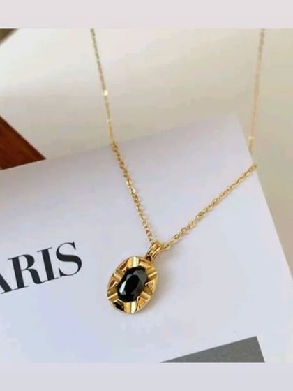 My oval pendant necklace with a polished black stone. The simple design makes it a versatile piece that adds a touch of sophistication to any outfit.