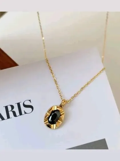 My oval pendant necklace with a polished black stone. The simple design makes it a versatile piece that adds a touch of sophistication to any outfit.