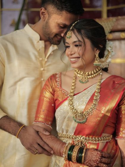 A happy moment between the couple. The bride's makeup is natural and glowing, enhancing her beauty without overpowering her features.