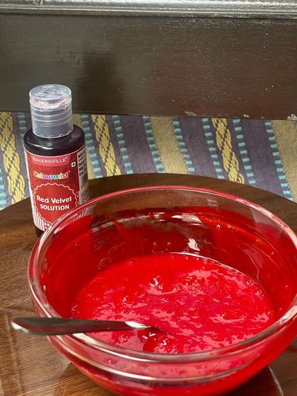 The initial stage of my red velvet brownie batter, showing the high-quality food coloring I use to achieve that classic deep red hue.