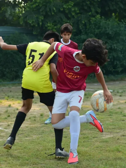 A player uses his body to shield the ball while executing a skillful touch. This shows a high level of game intelligence.