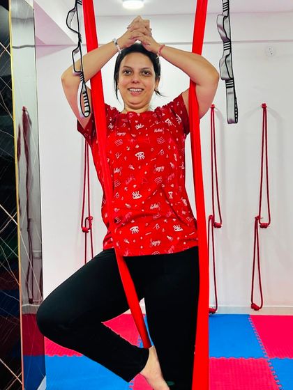 Every class is a chance to try something new and have fun. This student finds her balance in a supported tree pose, smiling as she masters the posture.
