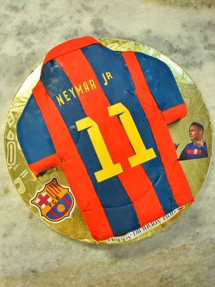 A cake for a die-hard Neymar Jr. fan, shaped and decorated like his number 11 FC Barcelona jersey.