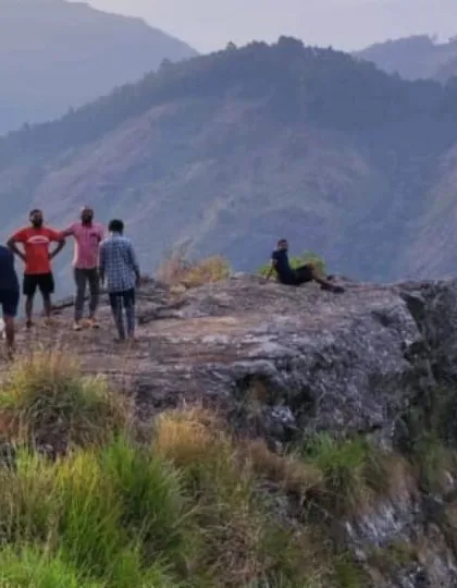 A group of friends enjoying the view from a cliff edge viewpoint during the Vattavada nature camp.