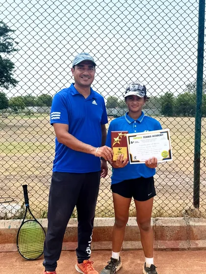 Siddhi Pandey receives her Runner-Up award in the Under-14 category at the Championship Series Tournament in Sonipat, pictured with her coach from our Noida center.