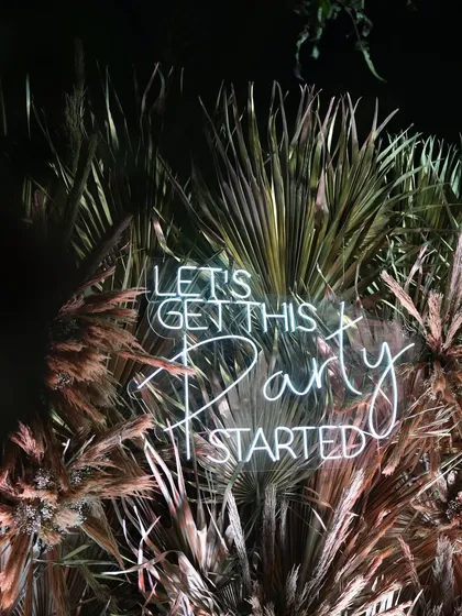 A fun neon sign that sets the mood for the Sangeet party. I use custom signage like this to add personality and a modern touch to the decor.