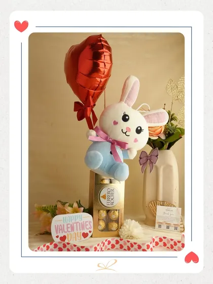 A cute and thoughtful Valentine's hamper featuring a plush bunny holding a heart balloon, alongside a box of Ferrero Rocher chocolates. It’s a simple yet adorable way to show you care.