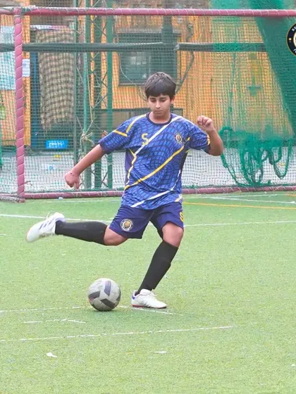 Taking a penalty or a direct free-kick requires composure. This shot captures the focus of one of our players as he prepares to strike the ball during a crucial moment in the game.