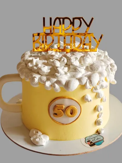 A fun beer mug cake for a 50th birthday. The whipped cream foam on top makes it look just like a frothy mug of beer.