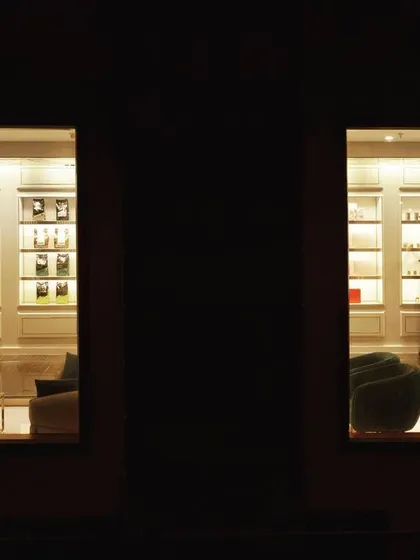 An exterior night shot looking into a warmly lit interior, creating a series of "framed views." This image captures our approach of orchestrating a play of light and obscurity, blurring the boundary between inside and outside.