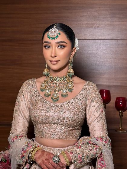 The complete look. The soft makeup complements the pastel outfit and the heavy jewelry perfectly.