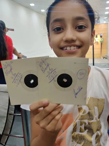 A happy and proud Bhavya showing off her two perfect 50/50 target cards. Her smile says it all.