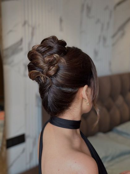 A side view of the intricate topknot, highlighting its volume and sophisticated structure.