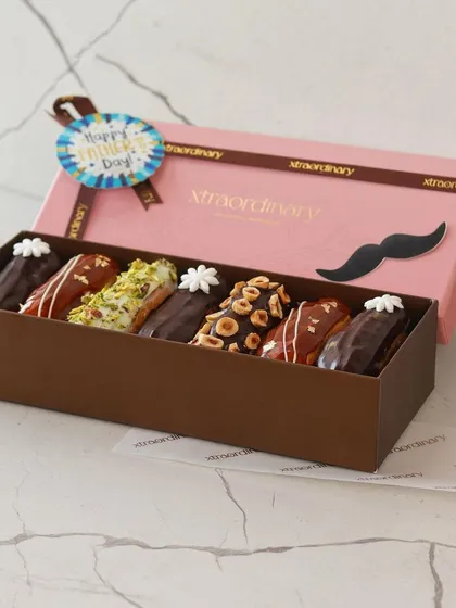 Another angle of our Father's Day eclair box, showing the beautiful packaging and the variety of flavors inside.