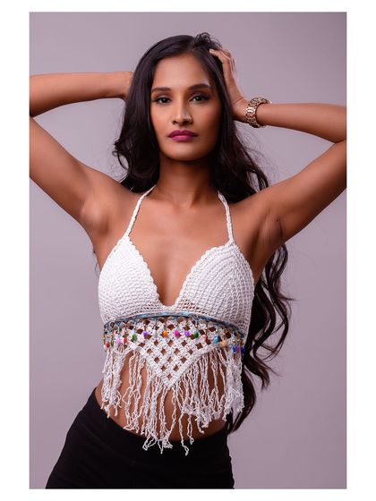 A pose that showcases the model's hair and the back details of the halter top.