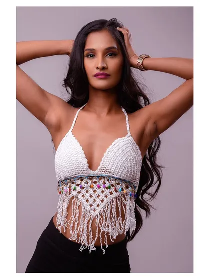 A pose that showcases the model's hair and the back details of the halter top.
